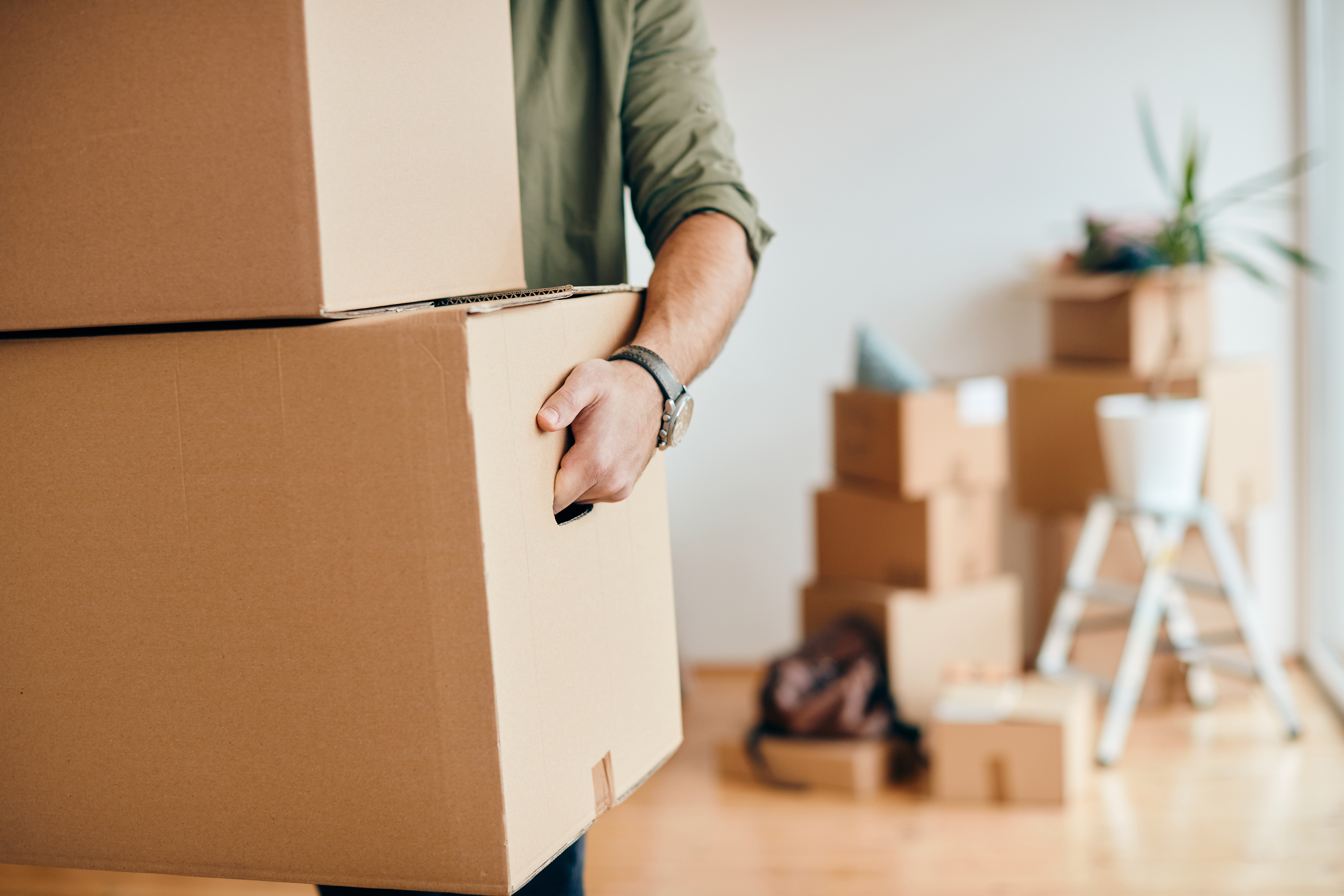 Man carrying cardboard boxes while relocating